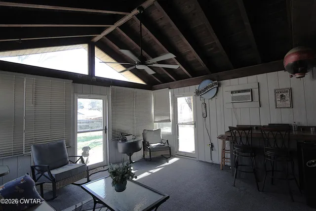 a view of a livingroom with furniture and a ceiling fan