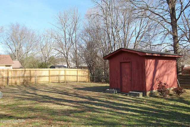 a view of a house with a yard in front of it