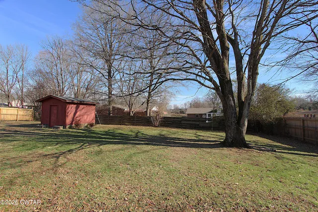 a view of a patio with table and chairs and potted plants