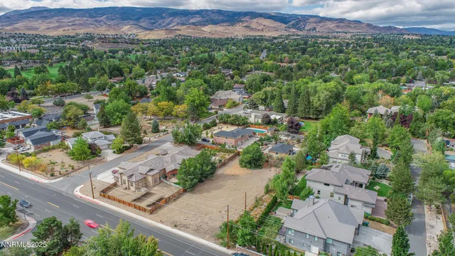 an aerial view of residential houses with outdoor space and street view