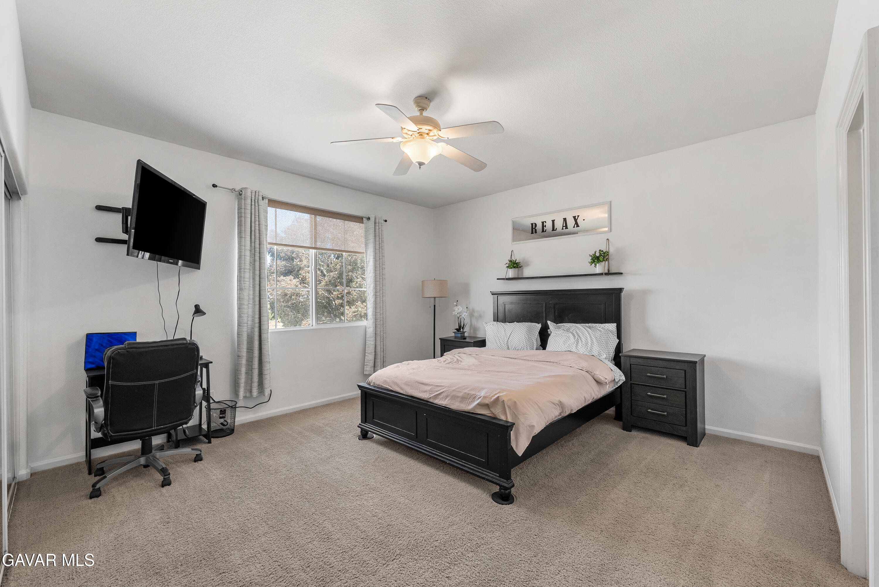 658 Lago Lindo Road Palmdale, CA 93550 - Photo 66 of 91 a bedroom with a bed and a flat screen tv