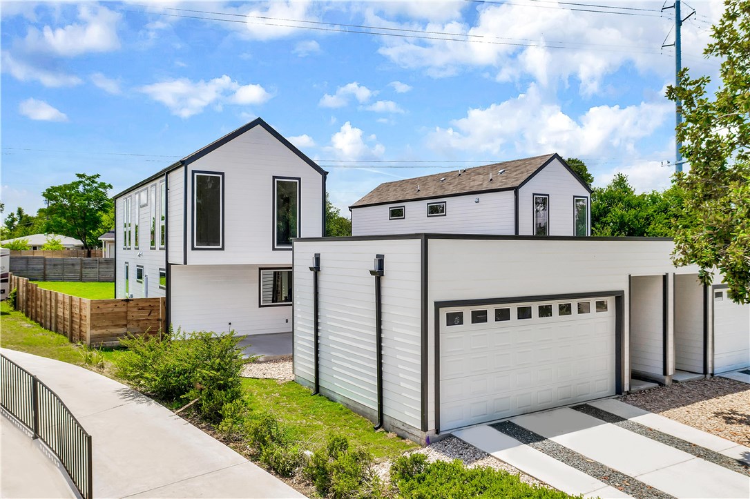 a view of a house with a yard and garage