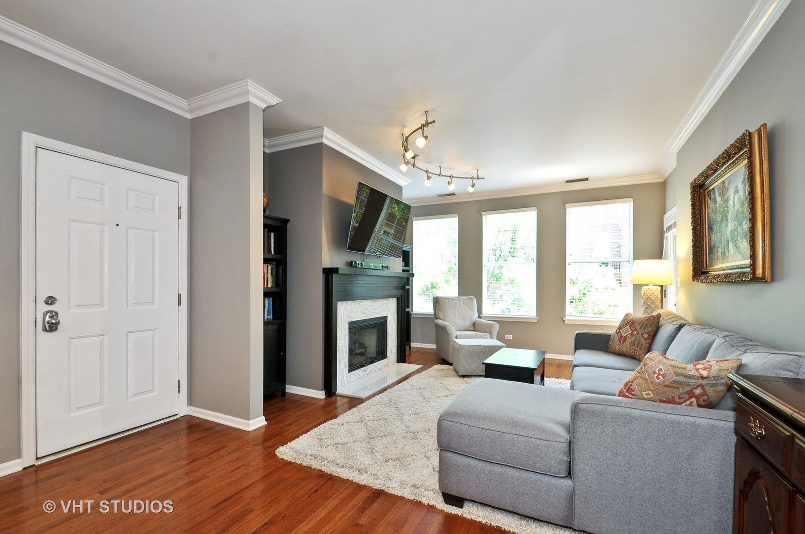 301 West Scott Street, Unit 204 Chicago, IL 60610 - Photo 3 of 11 a living room with furniture fireplace and flat screen tv