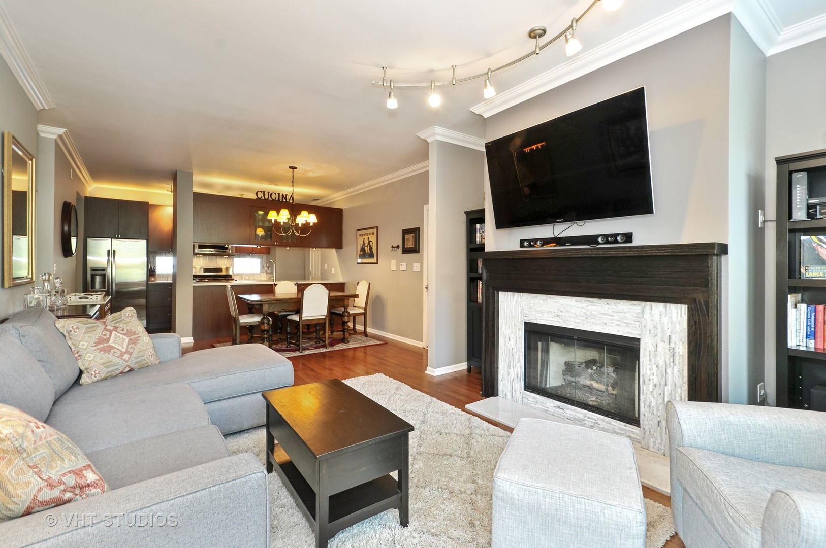 301 West Scott Street, Unit 204 Chicago, IL 60610 - Photo 4 of 11 a living room with furniture a flat screen tv and a fireplace