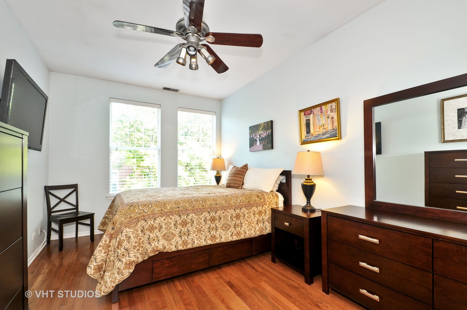 301 West Scott Street, Unit 204 Chicago, IL 60610 - Photo 7 of 11 a bedroom with a bed and a dresser with the mirror