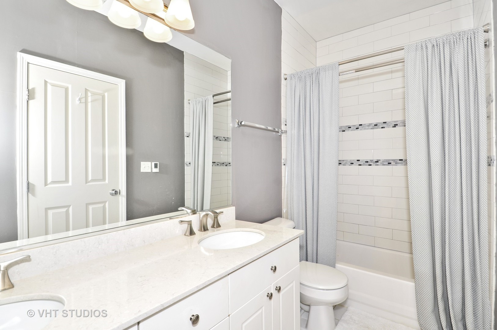 301 West Scott Street, Unit 204 Chicago, IL 60610 - Photo 8 of 11 a bathroom with a granite countertop sink toilet and shower