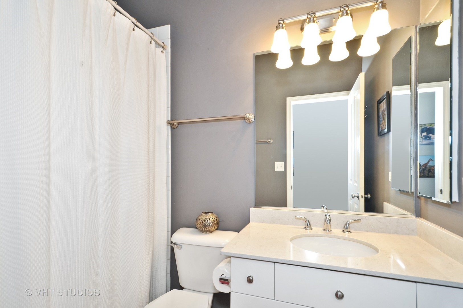 301 West Scott Street, Unit 204 Chicago, IL 60610 - Photo 10 of 11 a bathroom with a sink and a mirror