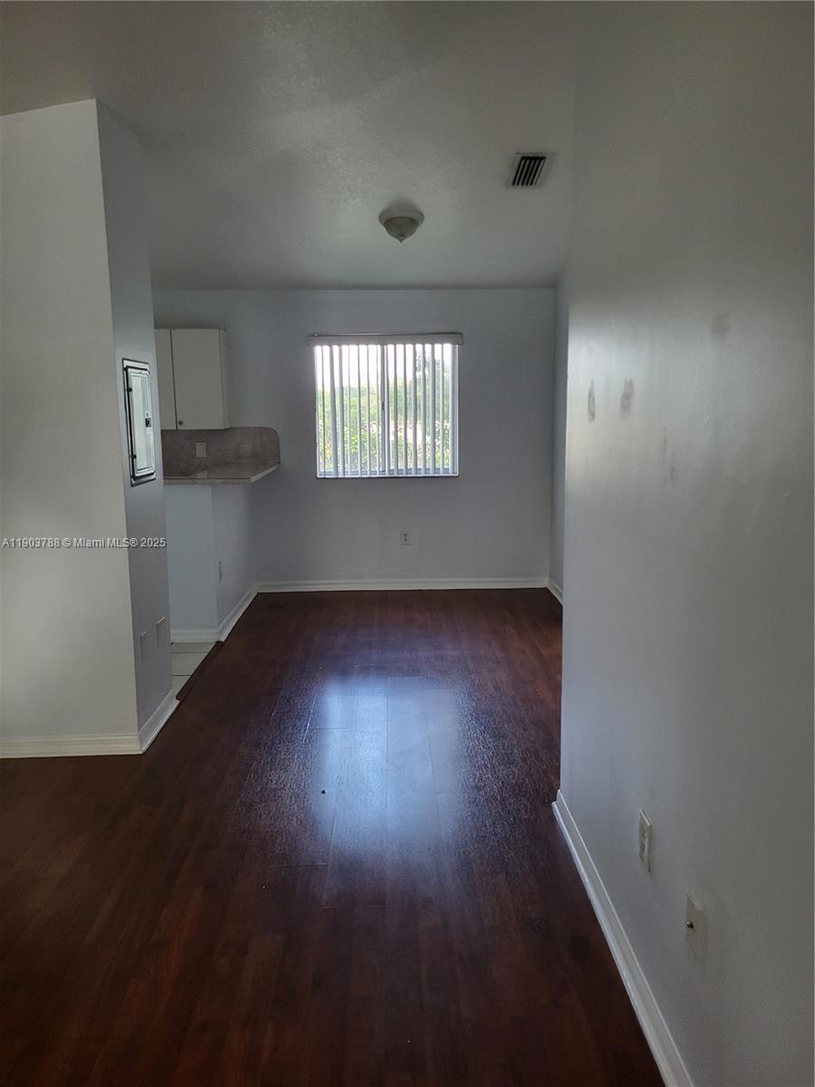 2920 Southeast 12th Road, Unit 20130 Homestead, FL 33035 - Photo 11 of 11 an empty room with wooden floor and windows