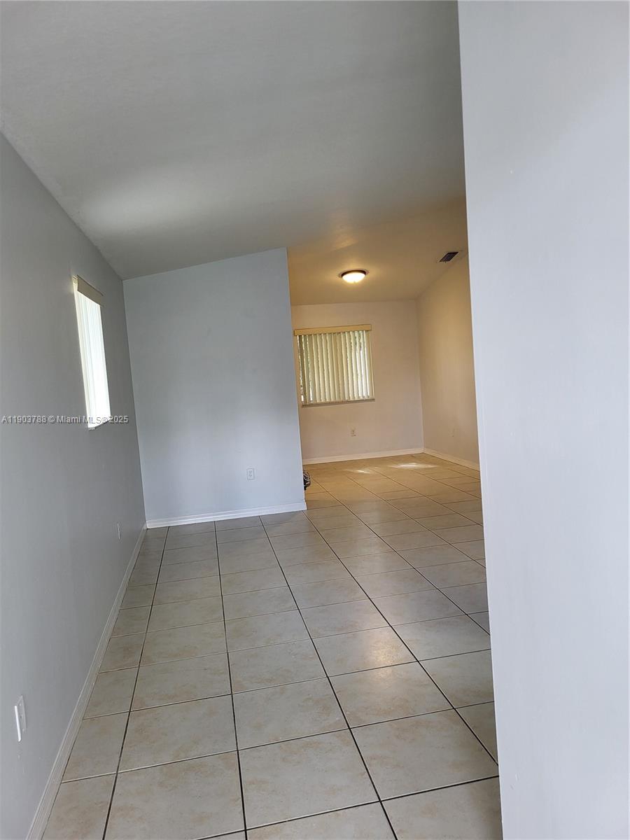 2920 Southeast 12th Road, Unit 20130 Homestead, FL 33035 - Photo 3 of 11 a view of a livingroom with an empty space and a window