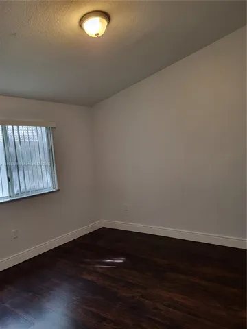 a view of an empty room and wooden floor