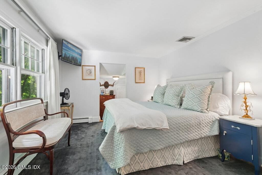 73 Thunder Mountain Road Greenwich, CT 06831 - Photo 10 of 19 a bedroom with a bed and wooden floor