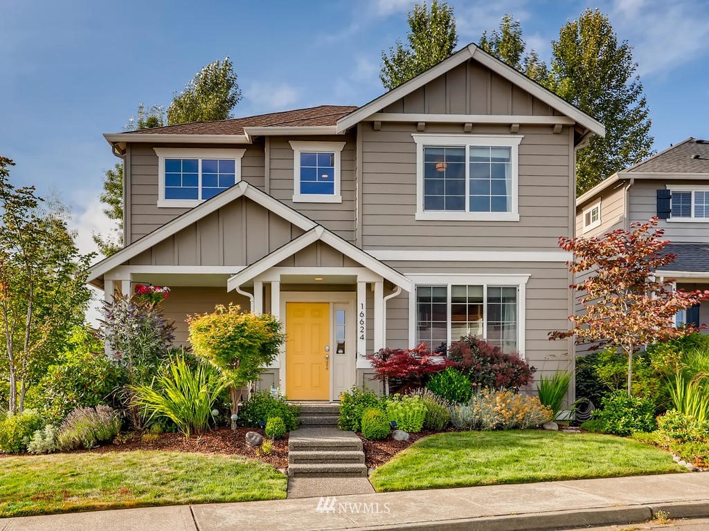 a front view of a house with garden