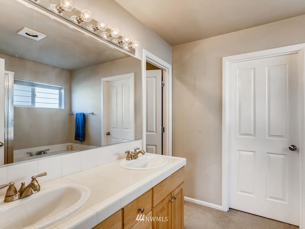 16624 Southeast 169th Street Renton, WA 98058 - Photo 14 of 21 a bathroom with a sink and a mirror