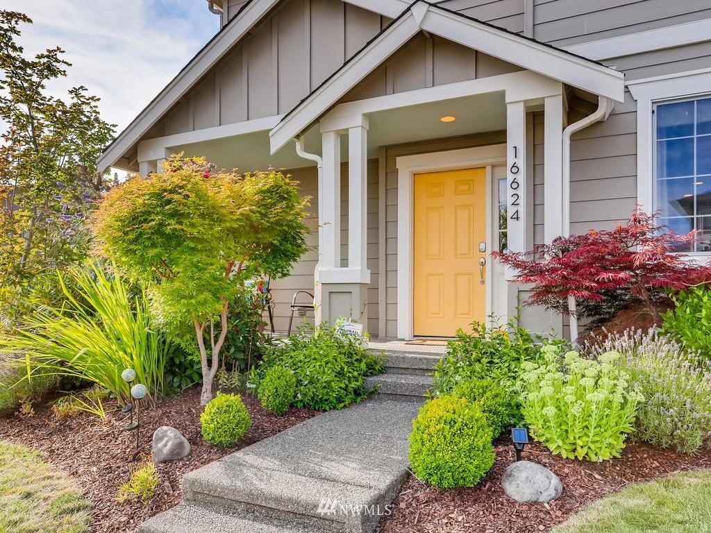 16624 Southeast 169th Street Renton, WA 98058 - Photo 3 of 21 a front view of a house with garden