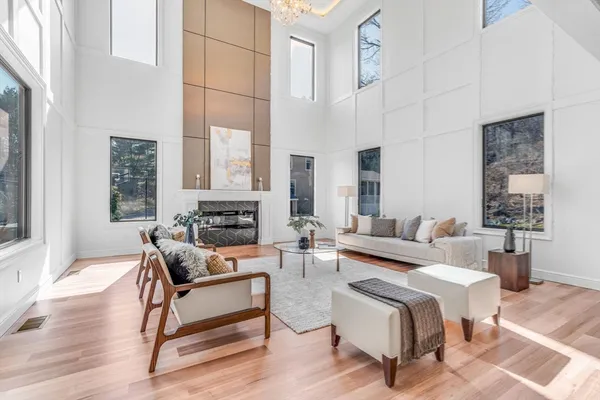 a living room with furniture wooden floor and a table