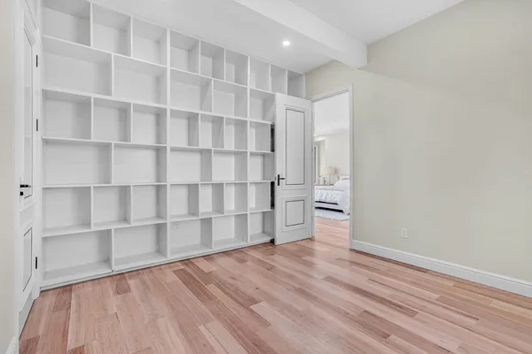 a view of wooden floor and windows in a room