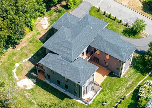 an aerial view of a house with a yard