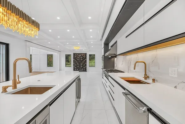 a kitchen with sink and white cabinets