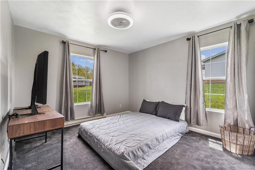 2109 Ridge Boulevard Connellsville, PA 15425 - Photo 12 of 22 a bedroom with a bed and a flat tv screen next to a window