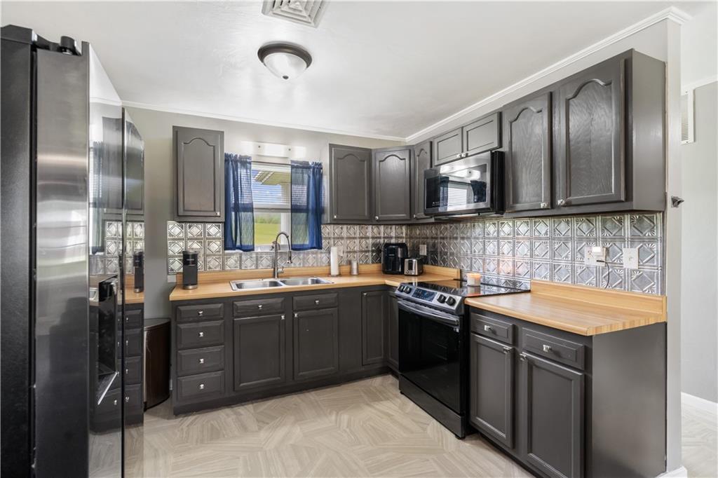 2109 Ridge Boulevard Connellsville, PA 15425 - Photo 7 of 22 a kitchen with stainless steel appliances granite countertop a sink stove and refrigerator
