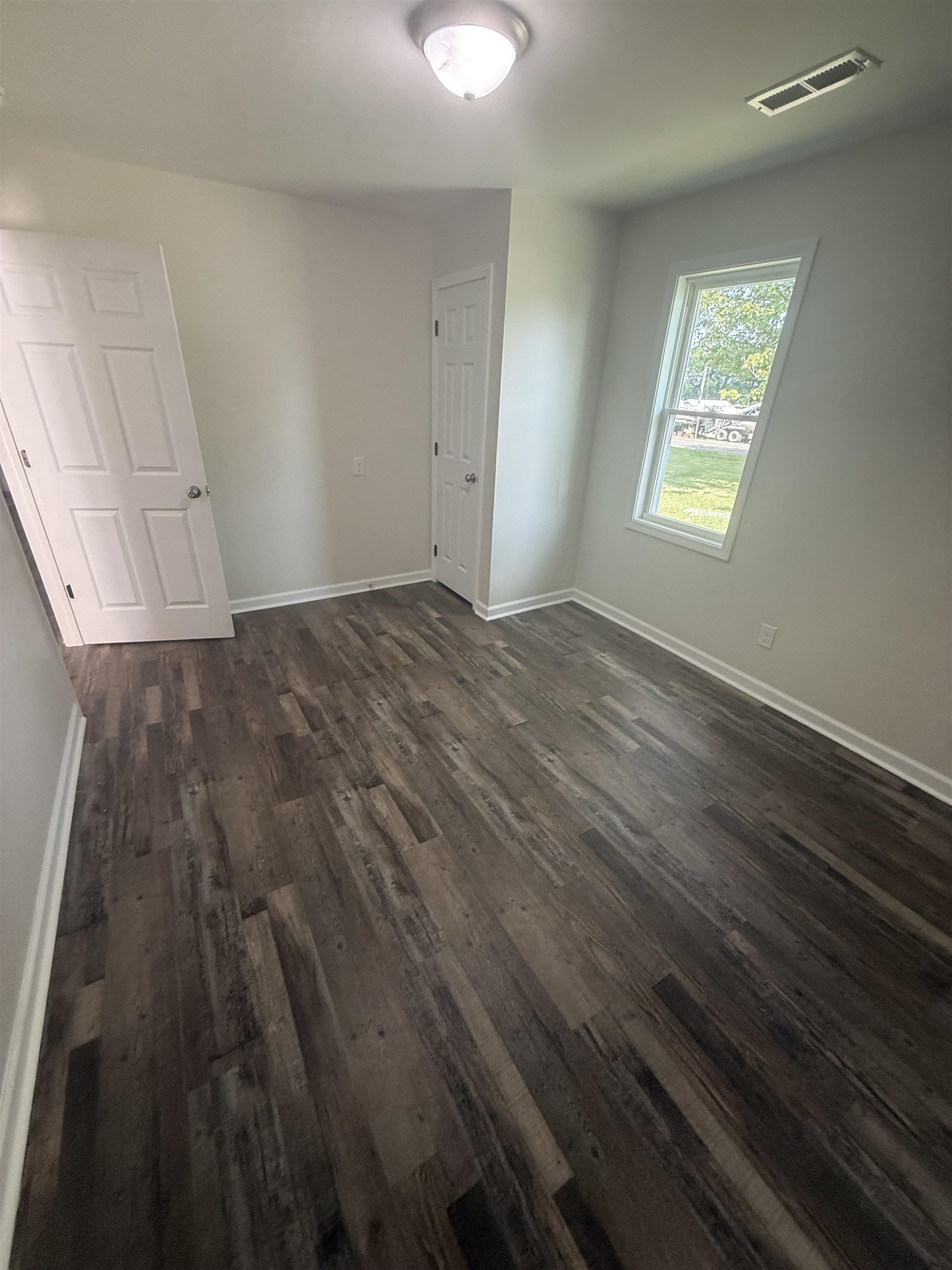 170 Leapwood Road Enville, TN 38332 - Photo 22 of 33 Room featuring wood-finish flooring, white baseboards, and light-toned walls