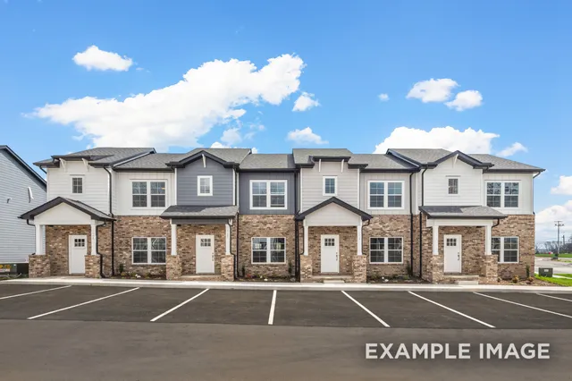 a front view of a residential houses with yard