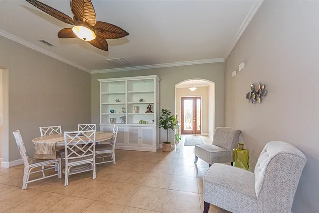 a dining room with furniture a chandelier and a rug