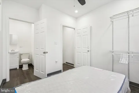 a spacious bedroom with a bed and a view of bathroom