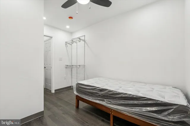 a bedroom with wooden floor