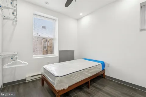 a bedroom with a bed and a window