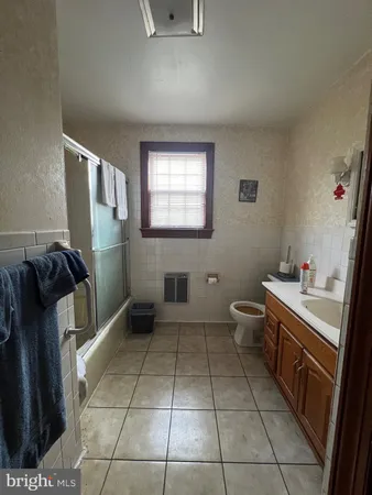 a bathroom with a tub toilet and sink