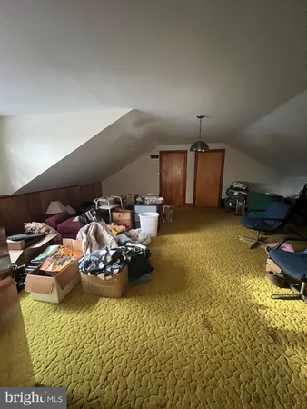 a bedroom with a bed and a flat tv screen on wall
