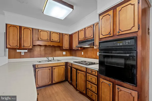 a kitchen with stainless steel appliances granite countertop a stove microwave and cabinets
