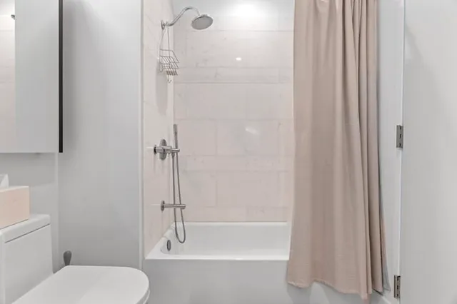 a bathroom with a toilet and shower