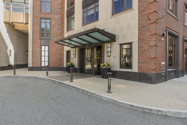 100 Lovejoy Place, Unit 12Q Boston, MA 02114 - Photo 12 of 13 a building with a table and chairs in front of building
