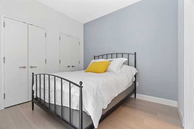 100 Lovejoy Place, Unit 12Q Boston, MA 02114 - Photo 8 of 13 a bedroom with a bed and lamps