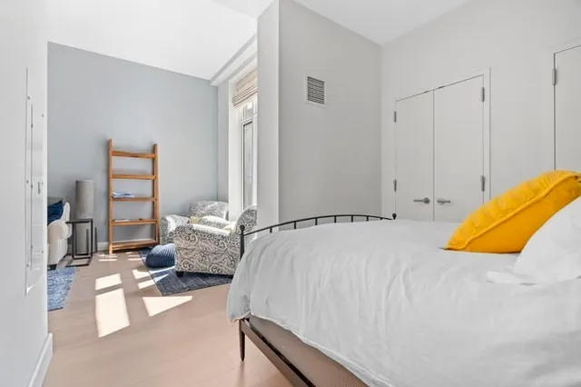 a bedroom with a bed and couch