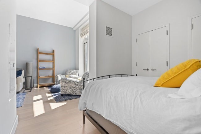 100 Lovejoy Place, Unit 12Q Boston, MA 02114 - Photo 9 of 13 a bedroom with a bed and couch