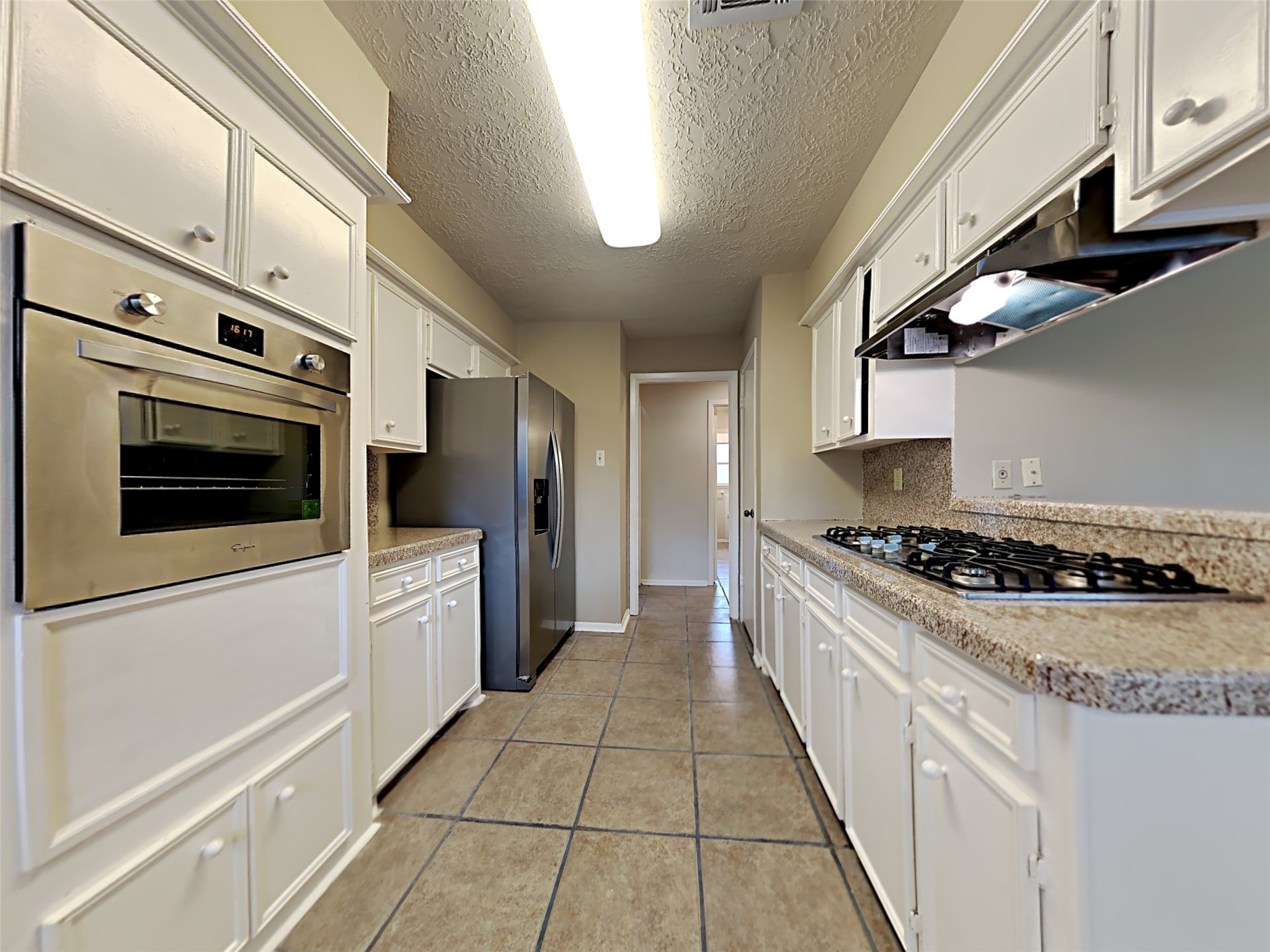 603 Blue Ridge Drive Shenandoah, TX 77381 - Photo 2 of 17 a kitchen with stainless steel appliances granite countertop a stove and a refrigerator