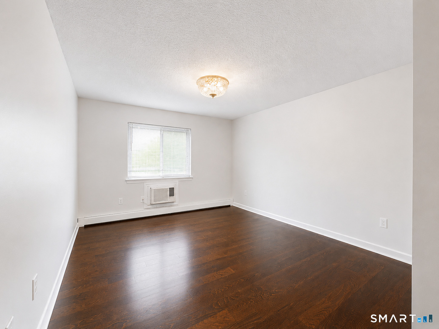 914 High Path Road, Unit 914 Windsor, CT 06095 - Photo 14 of 23 an empty room with wooden floor and windows