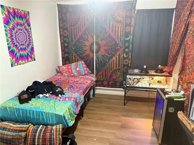 a bedroom with a bed and a wall painting