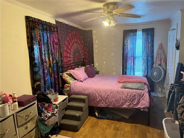 a bedroom with a bed and a chandelier