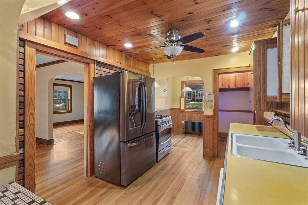 18 Windemere Road Worcester, MA 01602 - Photo 13 of 38 a view of a refrigerator in kitchen and dining room with wooden floor