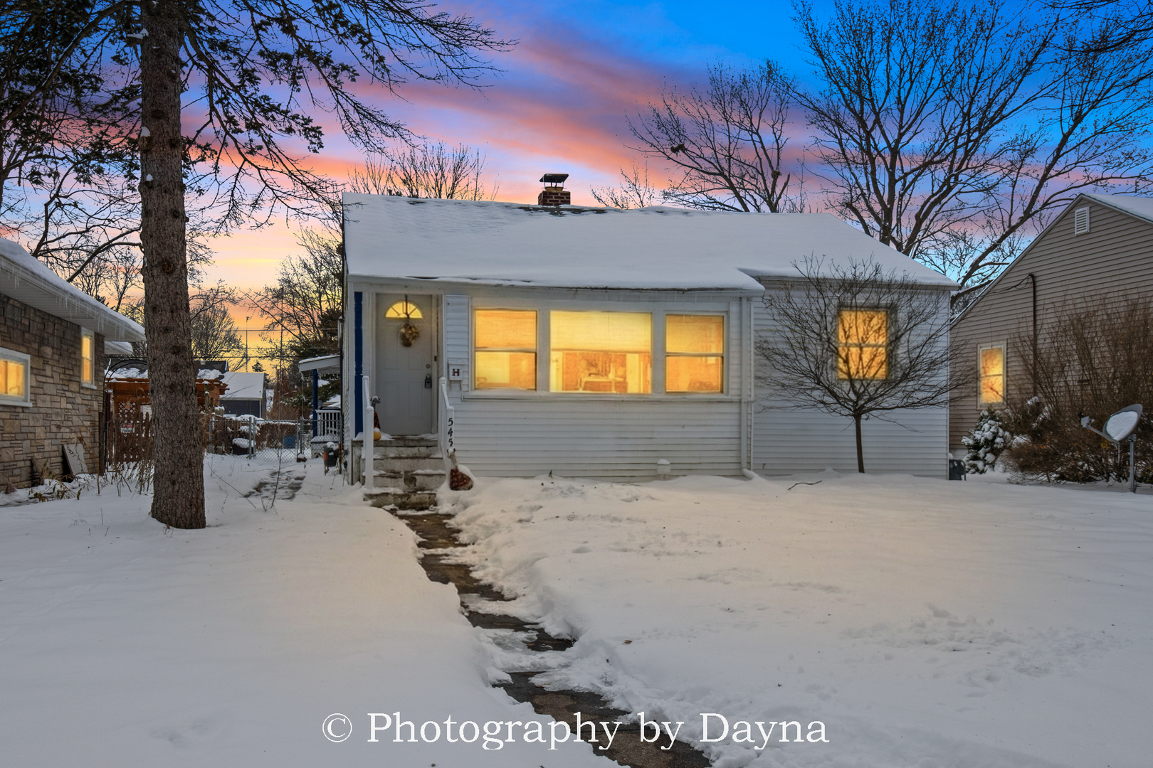 a view of a house with a snow in the yard