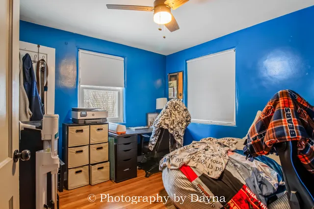 a bedroom with a bed and wooden floor