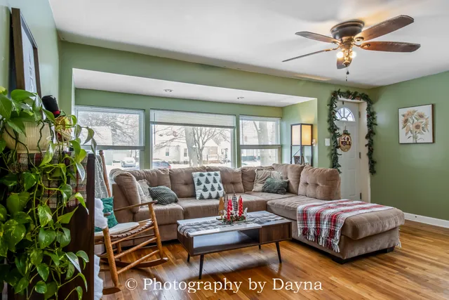 a living room with furniture and a potted plant