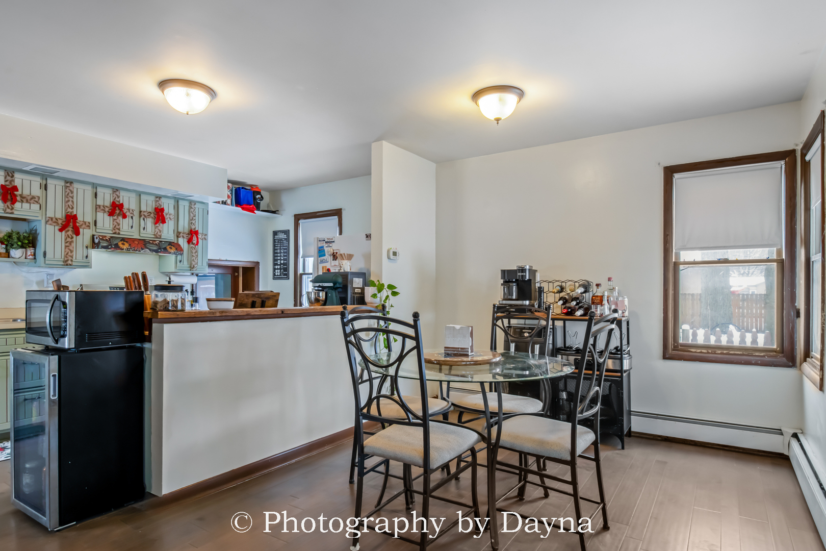 545 South Fraser Avenue Kankakee, IL 60901 - Photo 9 of 33 a kitchen with a dining table chairs and refrigerator