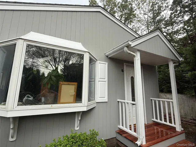 a view of a small house with wooden floor and a window