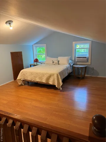 a bedroom with a bed and window