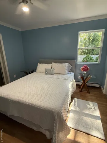 a bed sitting in a bedroom next to a window